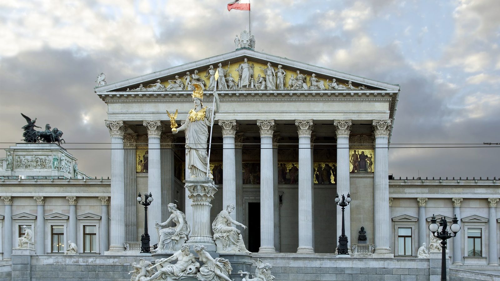 Facade of the Austrian Parliament in Vienna with the Pallas Athena statue in front of the columned portico.