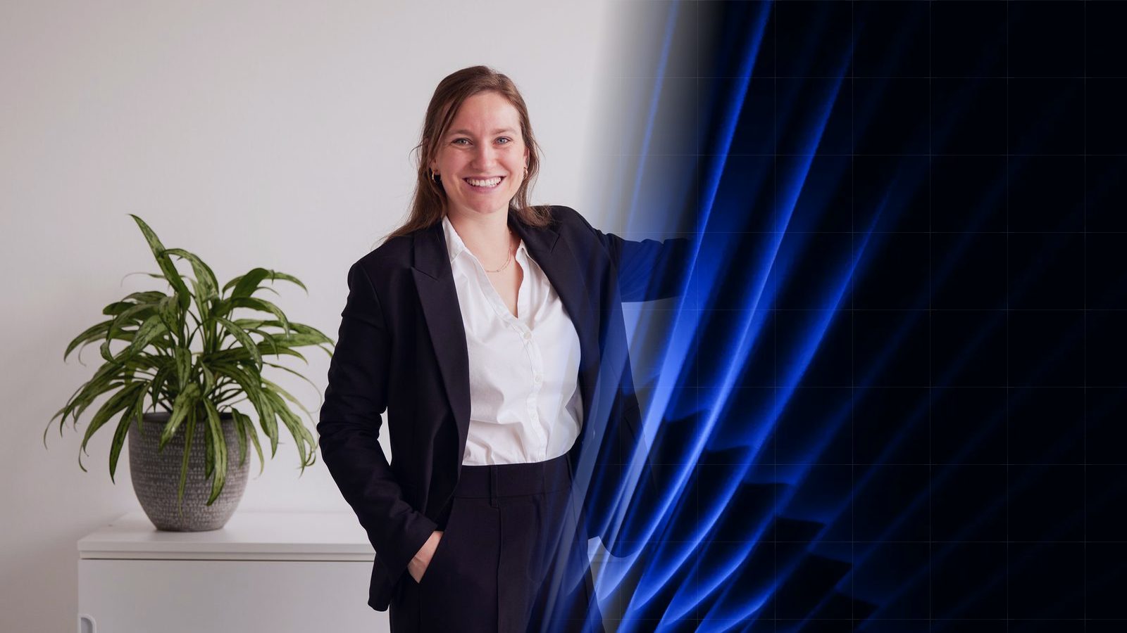 A ReqPOOL consultant stands in a bright office next to a green plant and gestures toward a blue graphic area with curved shapes.