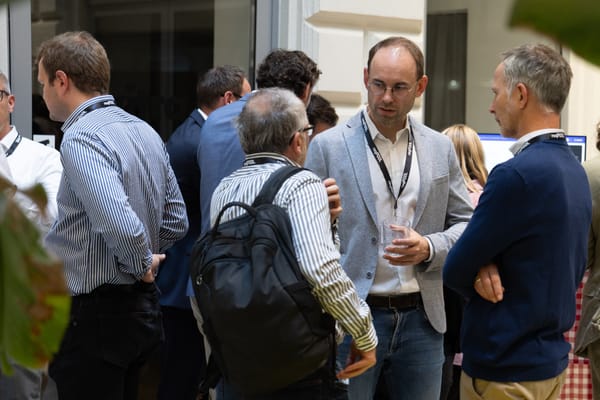 Group of guests with drinks in lively conversation