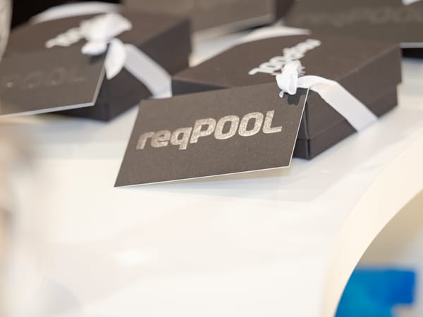 Guest gifts in black boxes with white ribbons and ReqPOOL tags