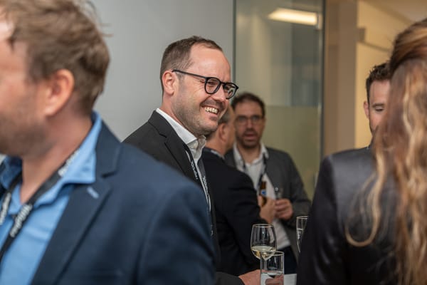 Smiling guest with glasses in conversation